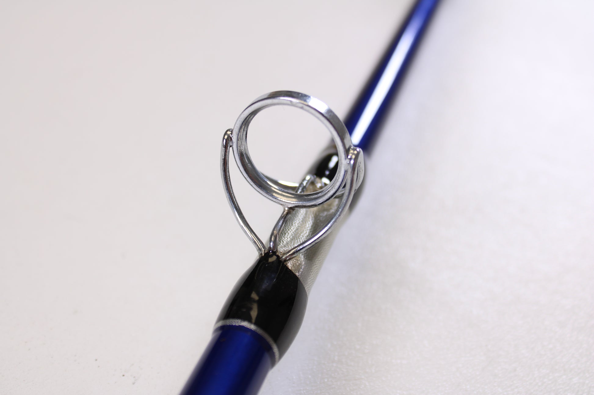 Close-up of a Shattered Cat 7'6" Heavy Used Casting Rod in excellent condition, highlighting a metal line guide—ideal for our Rod and Reel Trade-In Program if you're upgrading your Shattered Cat gear.