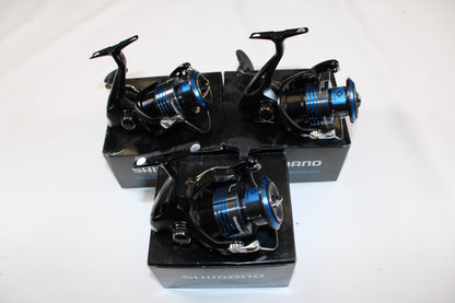 Three used Shimano Nexave 4000HGFI spinning reels in mint condition are shown atop their black boxes against a plain white background.