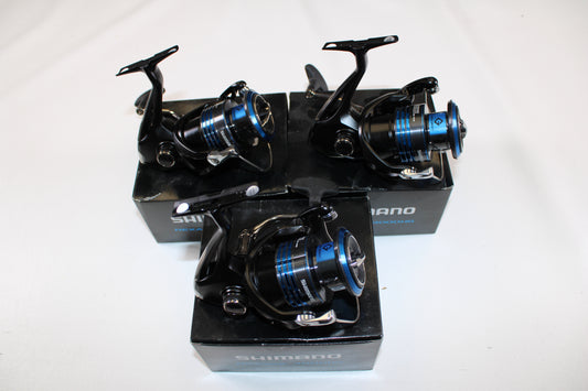 Three used Shimano Nexave 4000HGFI spinning reels in mint condition are shown atop their black boxes against a plain white background.