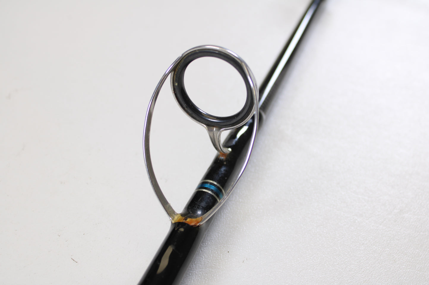 Close-up of a Cousins Tackle CLB 70XL-S 7'0" Extra Light used spinning rod’s line guide ring, metal supports, and blue thread—ideal for those trading gear in very good condition through our Rod and Reel Trade-In Program. Quantity: 2.
