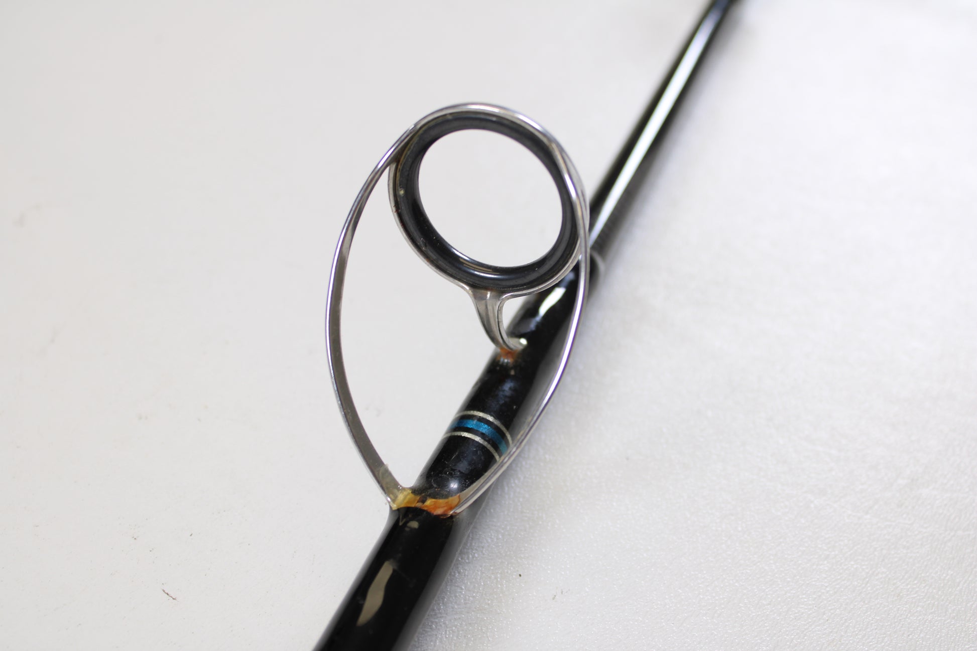 Close-up of a Cousins Tackle CLB 70XL-S 7'0" Extra Light used spinning rod’s line guide ring, metal supports, and blue thread—ideal for those trading gear in very good condition through our Rod and Reel Trade-In Program. Quantity: 2.