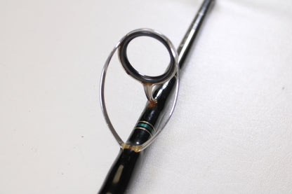A close-up of the Cousins Tackle CLB 70L-S 7'0" spinning rod guide ring, showing the metal loop on the black rod—ideal for displaying these Qty: 3 used rods in very good condition for a Rod and Reel Trade-In program.