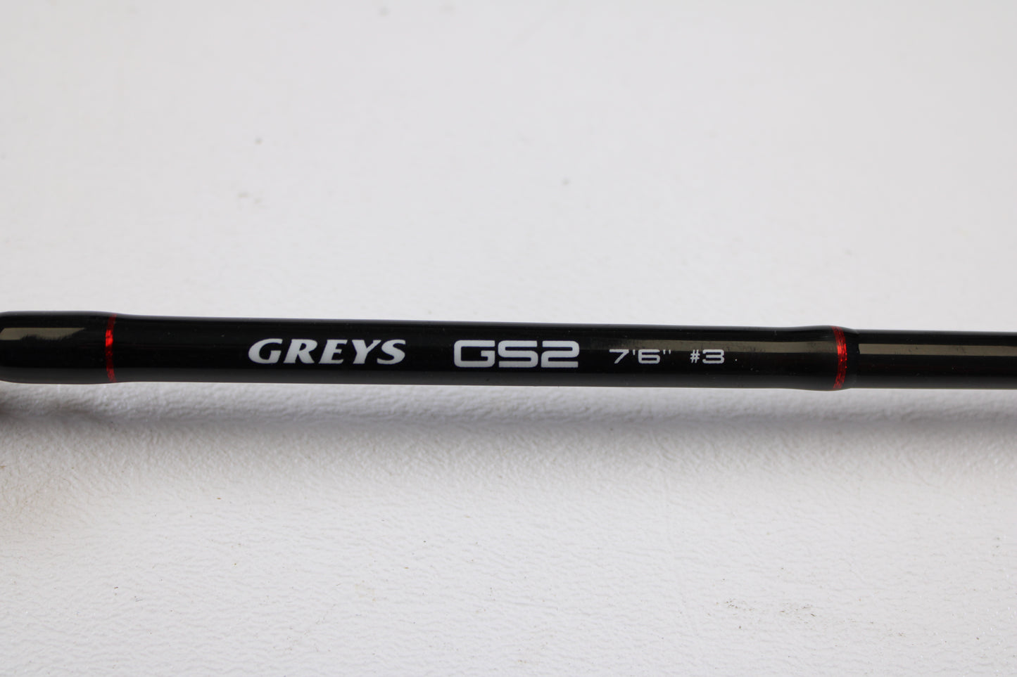 A close-up of a Greys GS2 7'6" 3wt 4 Piece Used Fly Rod in very good condition, with branding visible, set against a white background—ideal for those considering our Rod and Reel Trade-In Program for used gear or store credit.