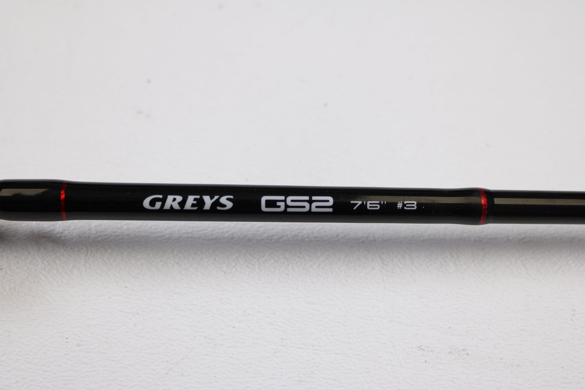 A close-up of a Greys GS2 7'6" 3wt 4 Piece Used Fly Rod in very good condition, with branding visible, set against a white background—ideal for those considering our Rod and Reel Trade-In Program for used gear or store credit.