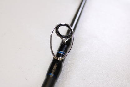 Close-up of two used Okuma Cedros Jigging 6'6" medium casting rods in excellent condition, featuring metallic guide rings and blue accents. Trade in your old gear for store credit with our rod and reel trade-in program.