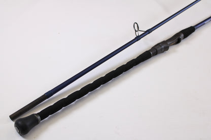 A close-up of the Tsunami SaltX Surf TSSTXIISS872M 8'7" Medium 2 Piece Used Spinning Rod—Excellent Condition—shows its black handle and reel seat, ideal for trading in through our Rod and Reel Trade-In Program for store credit.