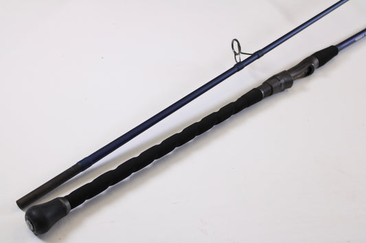 A close-up of the Tsunami SaltX Surf TSSTXIISS872M 8'7" Medium 2 Piece Used Spinning Rod—Excellent Condition—shows its black handle and reel seat, ideal for trading in through our Rod and Reel Trade-In Program for store credit.