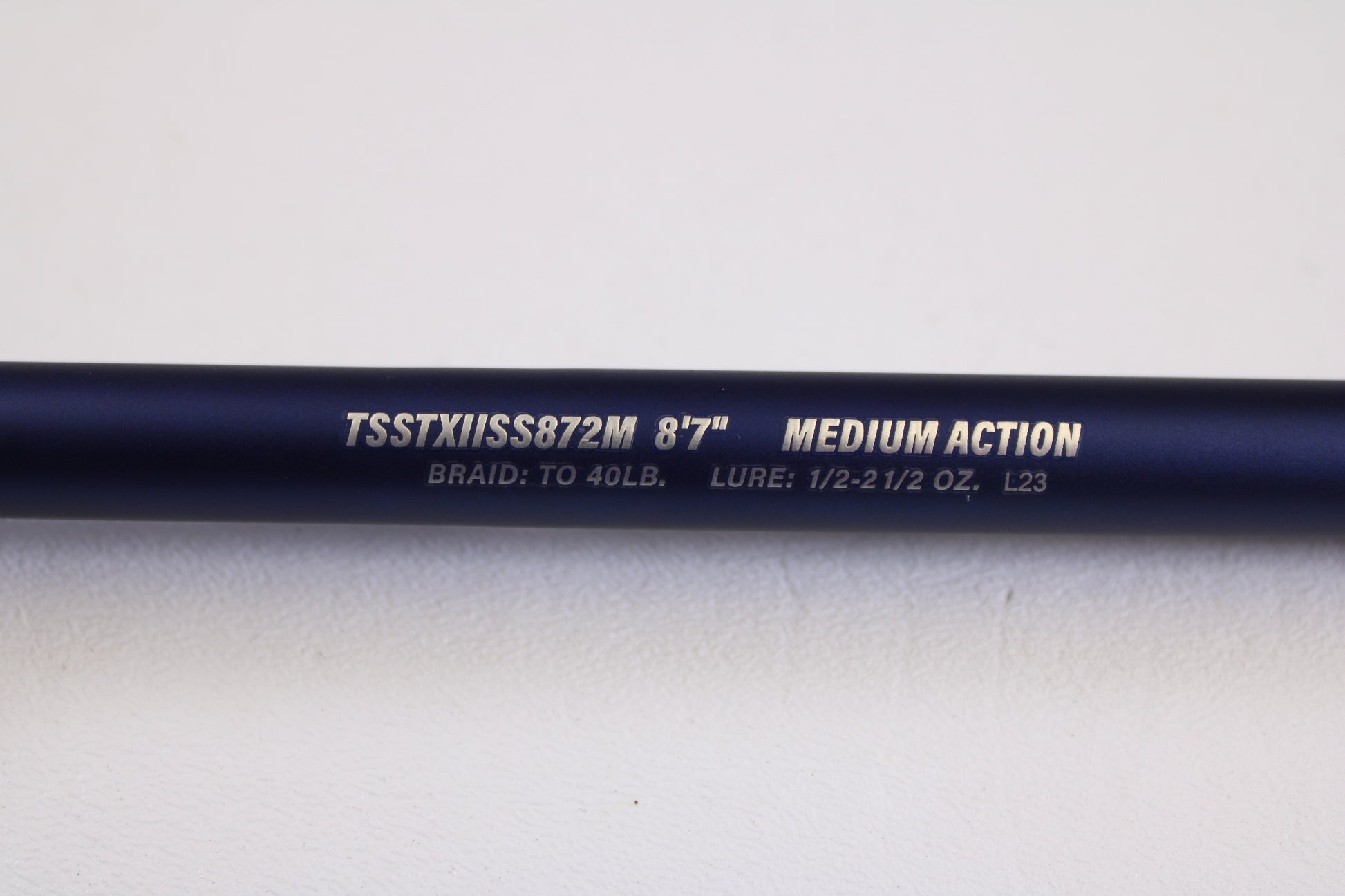 A close-up of a Tsunami SaltX Surf TSSTXIISS872M 8'7" Medium 2 Piece Used Spinning Rod in excellent condition—ideal for the Rod and Reel Trade-In Program and earning store credit.