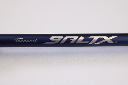 Close-up of the Tsunami SaltX Surf TSSTXIISS872M 8'7" Medium 2 Piece used spinning rod in excellent condition, shown against a white background. Trade in your gear through our Rod and Reel Trade-In Program for store credit.