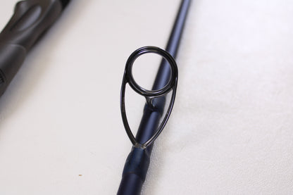 Close-up of the circular metal guide ring on a Tsunami SaltX Surf TSSTXIISS872M 8'7" Medium 2-Piece Spinning Rod (Used, Excellent Condition) by Tsunami—ideal for upgrade through our Rod and Reel Trade-In Program.