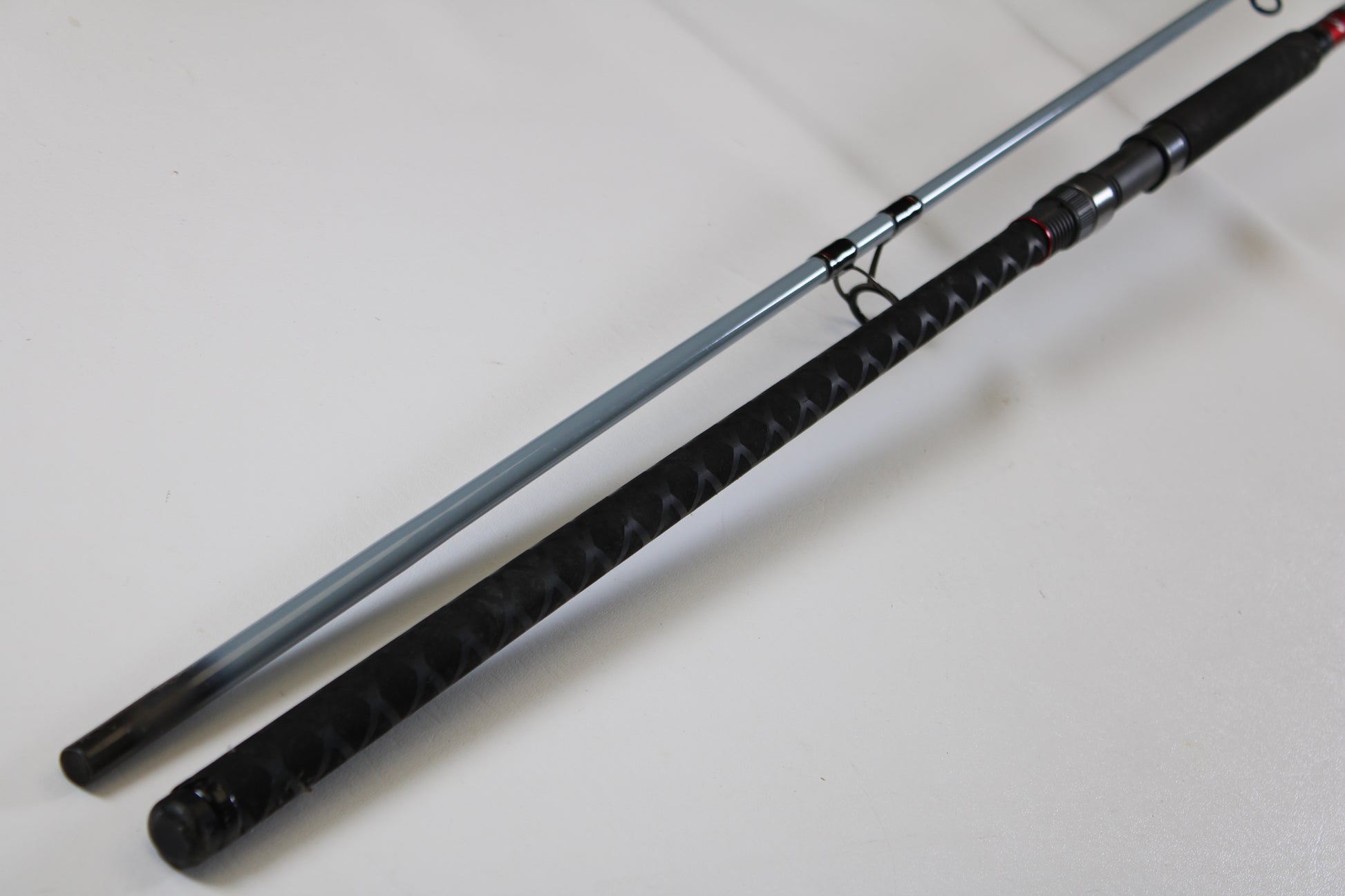 A close-up of the Daiwa Team Daiwa Surf TDSF1062MHFS 10'6" Medium Heavy Used Spinning Rod in very good condition showcases quality gear eligible for our Rod and Reel Trade-In Program.