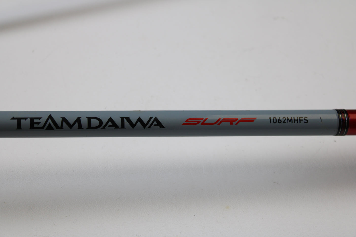 A close-up of the Daiwa Team Daiwa Surf TDSF1062MHFS 10'6" Medium Heavy Used Spinning Rod—ideal for anglers who want to upgrade through our Rod and Reel Trade-In Program and earn store credit for their used gear.