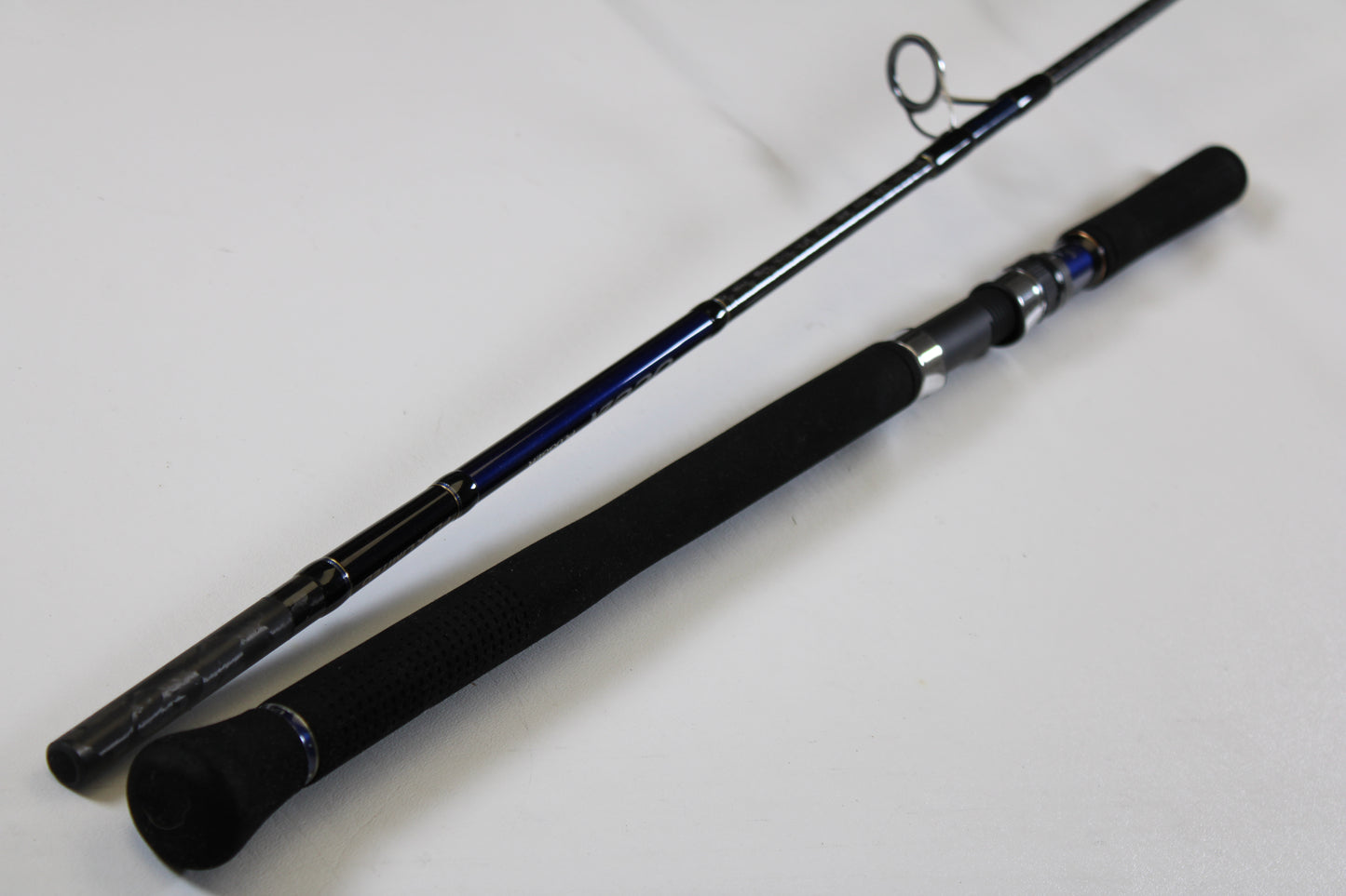 A close-up of a Shimano Ocea Plugger Flex Limited 7'10" Medium Light 2 Piece Used Spinning Rod in excellent condition, ideal for our Rod and Reel Trade-In Program—upgrade and earn store credit on your used Shimano gear.