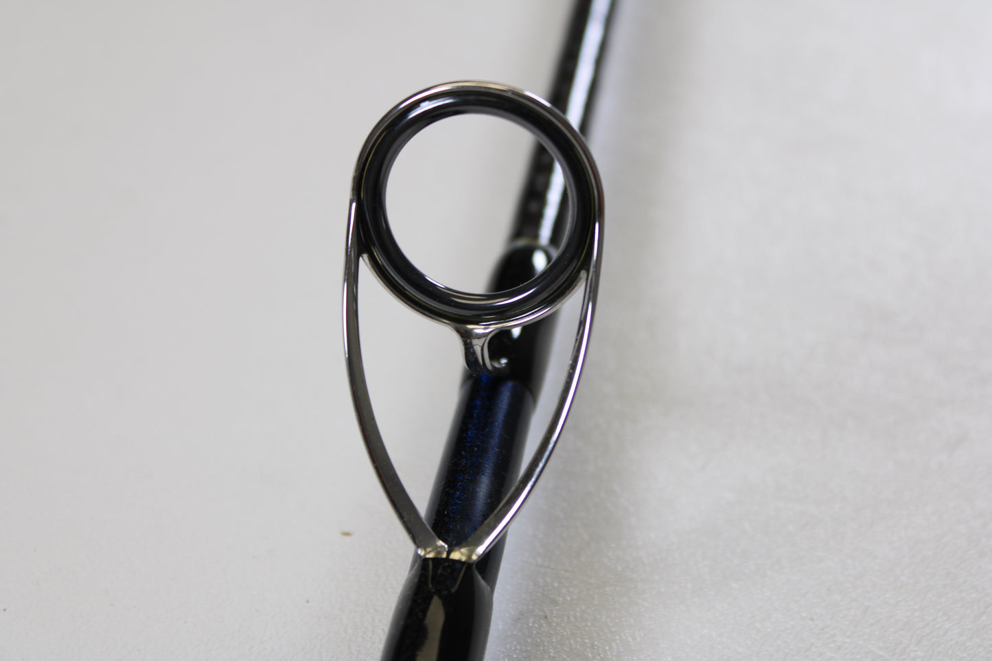 Close-up of the guide ring on the Shimano Ocea Plugger Flex Limited 7'10" Medium Light 2 Piece Used Spinning Rod in excellent condition—ideal for anyone exploring quality used Shimano gear.