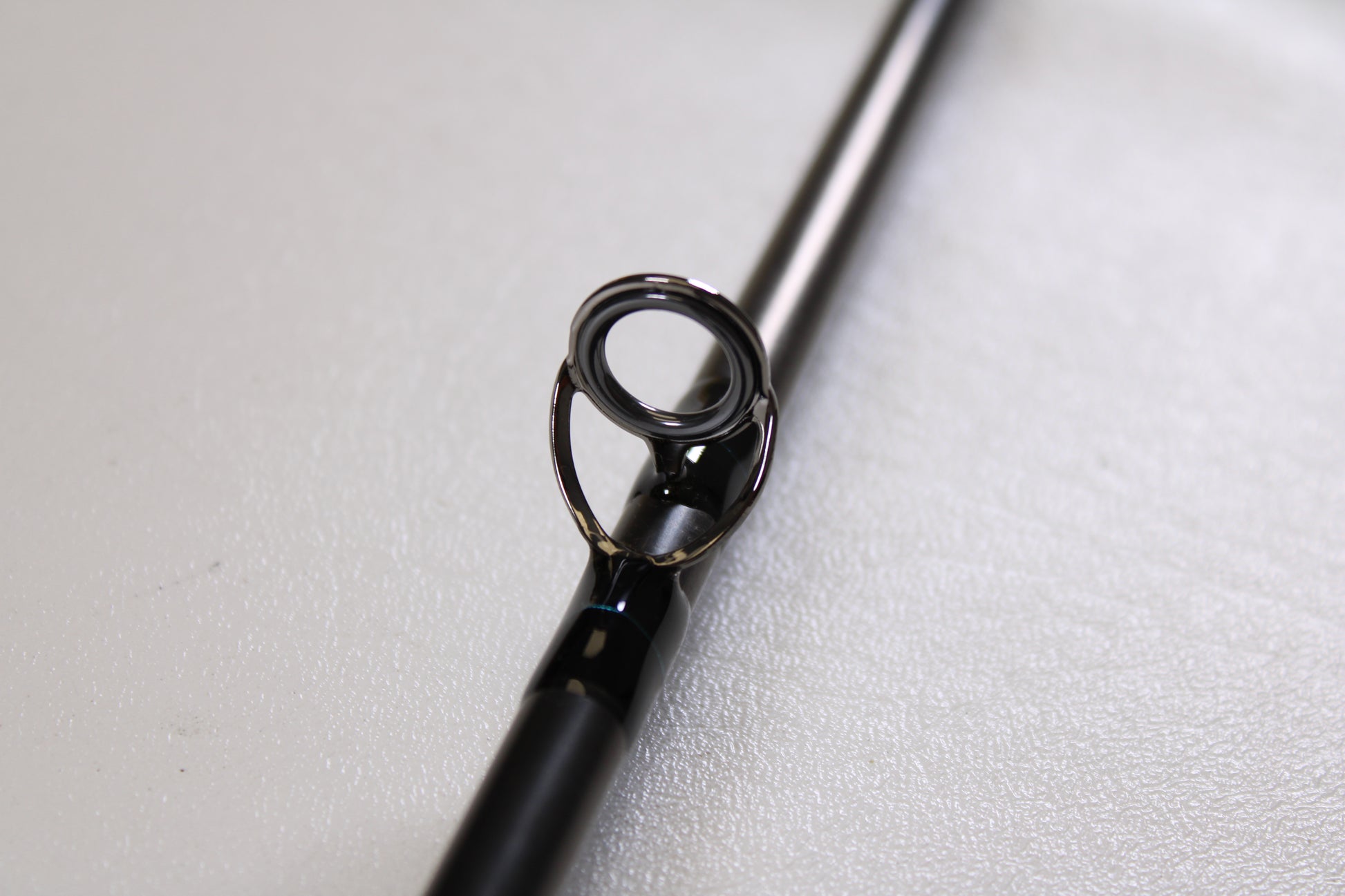 Close-up of a G. Loomis GLX FR1209 10'0" #9 2 Piece Used Fly Rod in excellent condition, highlighting its metal guide ring—ideal for trading in through our Rod and Reel Trade-In Program for store credit.