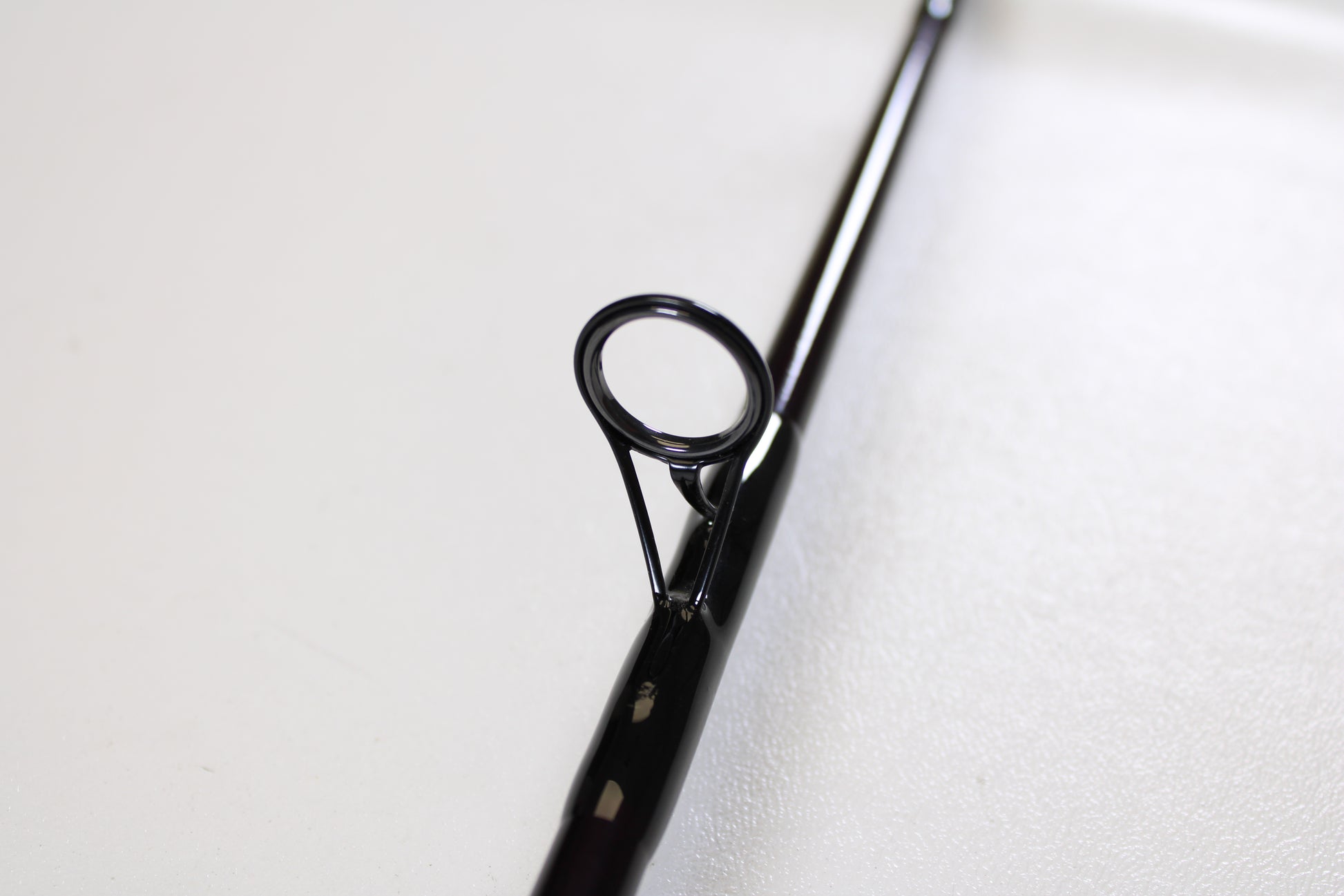 Close-up of a St. Croix Mojo Jig MJJS58XHMF 5'8" XH spinning rod guide, showing its circular eyelet and frame—ideal for anglers seeking used gear or a trade-in for store credit. Mint condition from St. Croix.