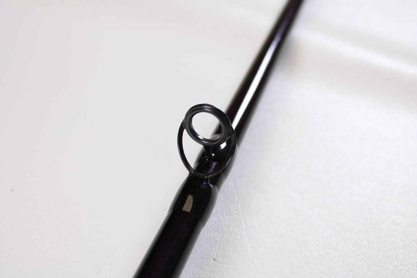 Close-up of a guide ring on the St. Croix Mojo Musky MJM80MHF 8'0" Medium Heavy Used Casting Rod—mint condition—ideal for those considering our Rod and Reel Trade-In Program or wanting store credit for upgrading gear.