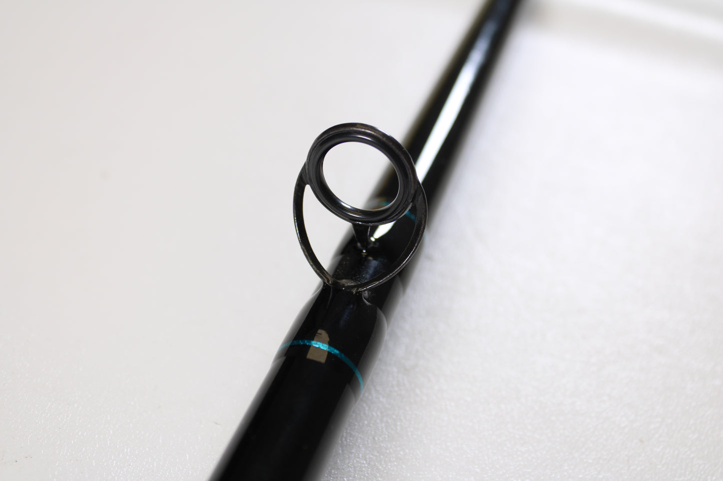 Close-up of a St. Croix Premier Musky PM80XHF 8'0" XH used casting rod in mint condition, featuring a black finish with metal guide ring and blue accents. Perfect for those seeking used gear or store credit via our trade-in program.