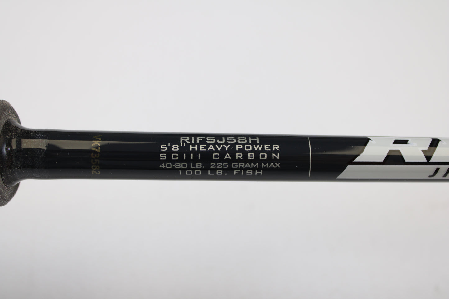 Close-up of a St. Croix Rift Jig RIFSJ58H 5'8" Heavy spinning rod in mint condition, showing white specs: SCIII carbon, 40-80 lb line, 225g max, rated for 100 lb fish. Eligible for our Rod and Reel Trade-In Program for store credit.