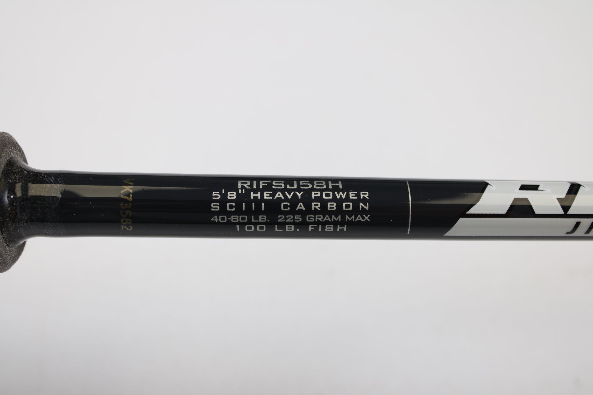 Close-up of a St. Croix Rift Jig RIFSJ58H 5'8" Heavy spinning rod in mint condition, showing white specs: SCIII carbon, 40-80 lb line, 225g max, rated for 100 lb fish. Eligible for our Rod and Reel Trade-In Program for store credit.