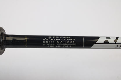 Close-up of a St. Croix Rift Jig RIFSJ58H 5'8" Heavy spinning rod in mint condition, showing white specs: SCIII carbon, 40-80 lb line, 225g max, rated for 100 lb fish. Eligible for our Rod and Reel Trade-In Program for store credit.