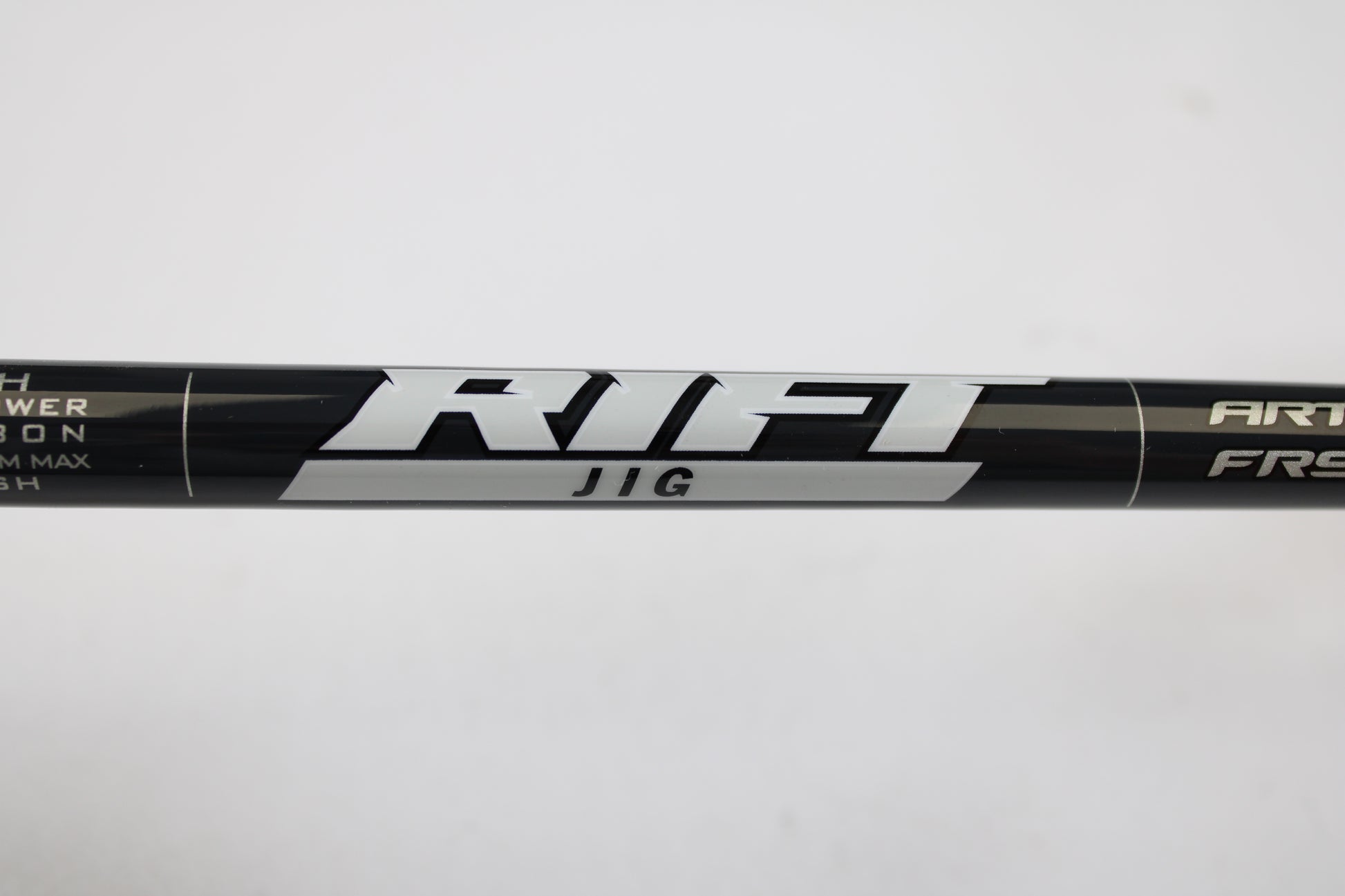 A close-up of the St. Croix Rift Jig RIFSJ58H 5'8" Heavy used spinning rod in mint condition, with "RIFT JIG" printed in silver—ideal for those interested in our Rod and Reel Trade-In Program for store credit.