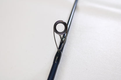 Close-up of a St. Croix Seage SES70MMF 7'0" Medium Used Spinning Rod in mint condition, highlighting the guide ring with its metal eyelet and supports—ideal for upgrading gear through our Trade-In Program. Shown on a plain white background.