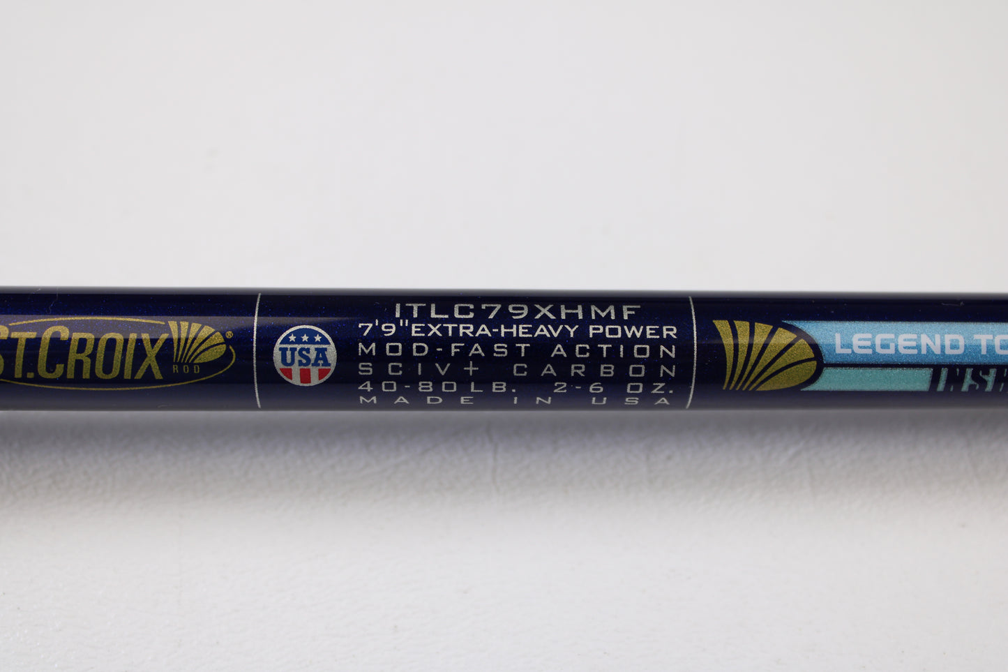 Close-up of a St. Croix Legend Tournament Inshore ITLC79XHMF 7'9" XH used casting rod label—extra-heavy, mod-fast, SCIV+ carbon, for 40-80 lb line & 2-6 oz lure. Trade-in eligible for store credit. Made in USA. Mint condition.