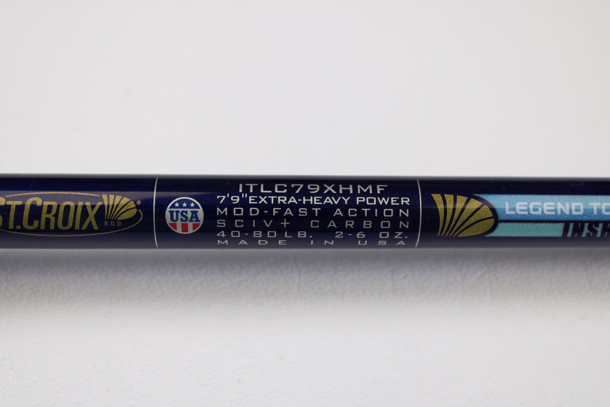 Close-up of a St. Croix Legend Tournament Inshore ITLC79XHMF 7'9" XH used casting rod label—extra-heavy, mod-fast, SCIV+ carbon, for 40-80 lb line & 2-6 oz lure. Trade-in eligible for store credit. Made in USA. Mint condition.