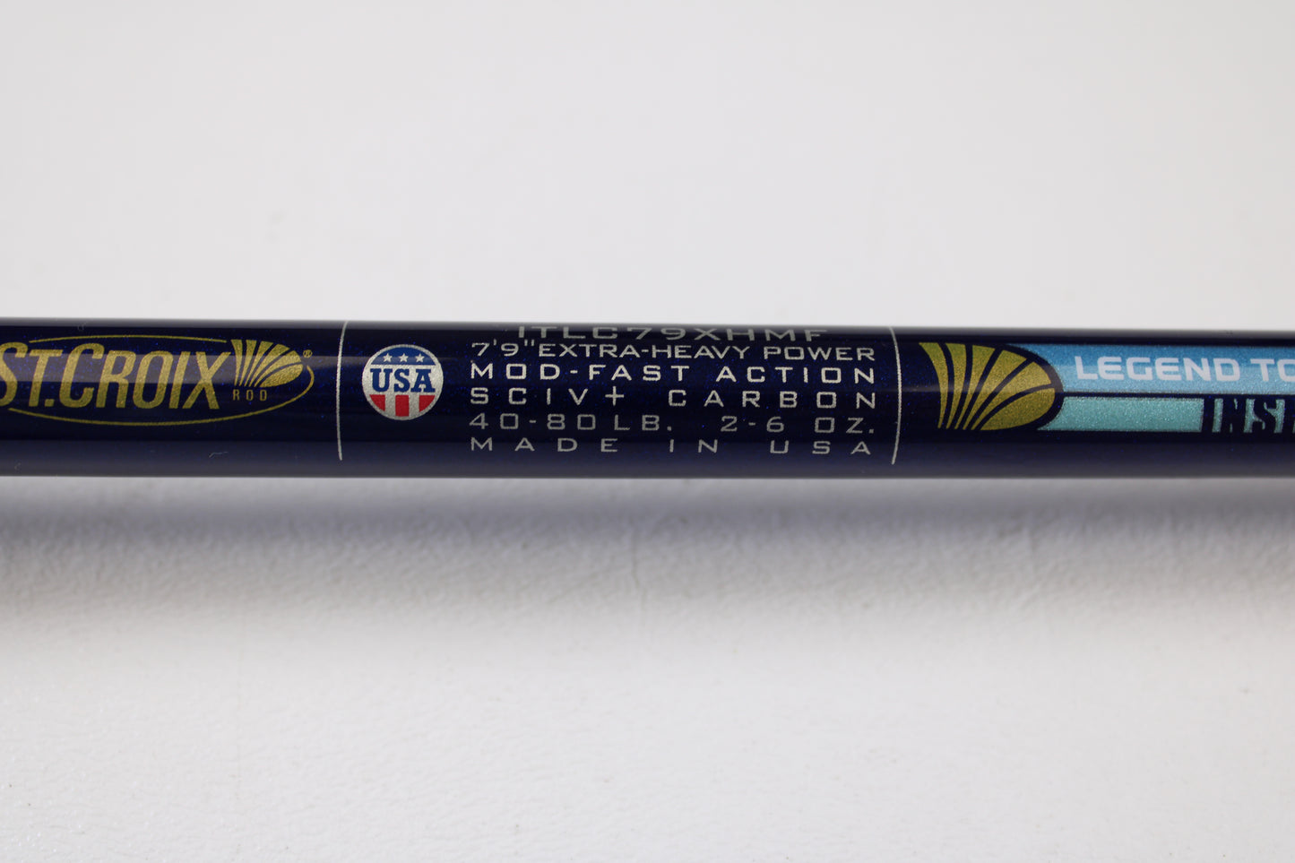 Close-up of a St. Croix Legend Tournament Inshore ITLC79XHMF 7'9" XH used casting rod in mint condition, featuring extra-heavy power, moderate-fast action, and blue/gold accents. Eligible for our Rod and Reel Trade-In Program.