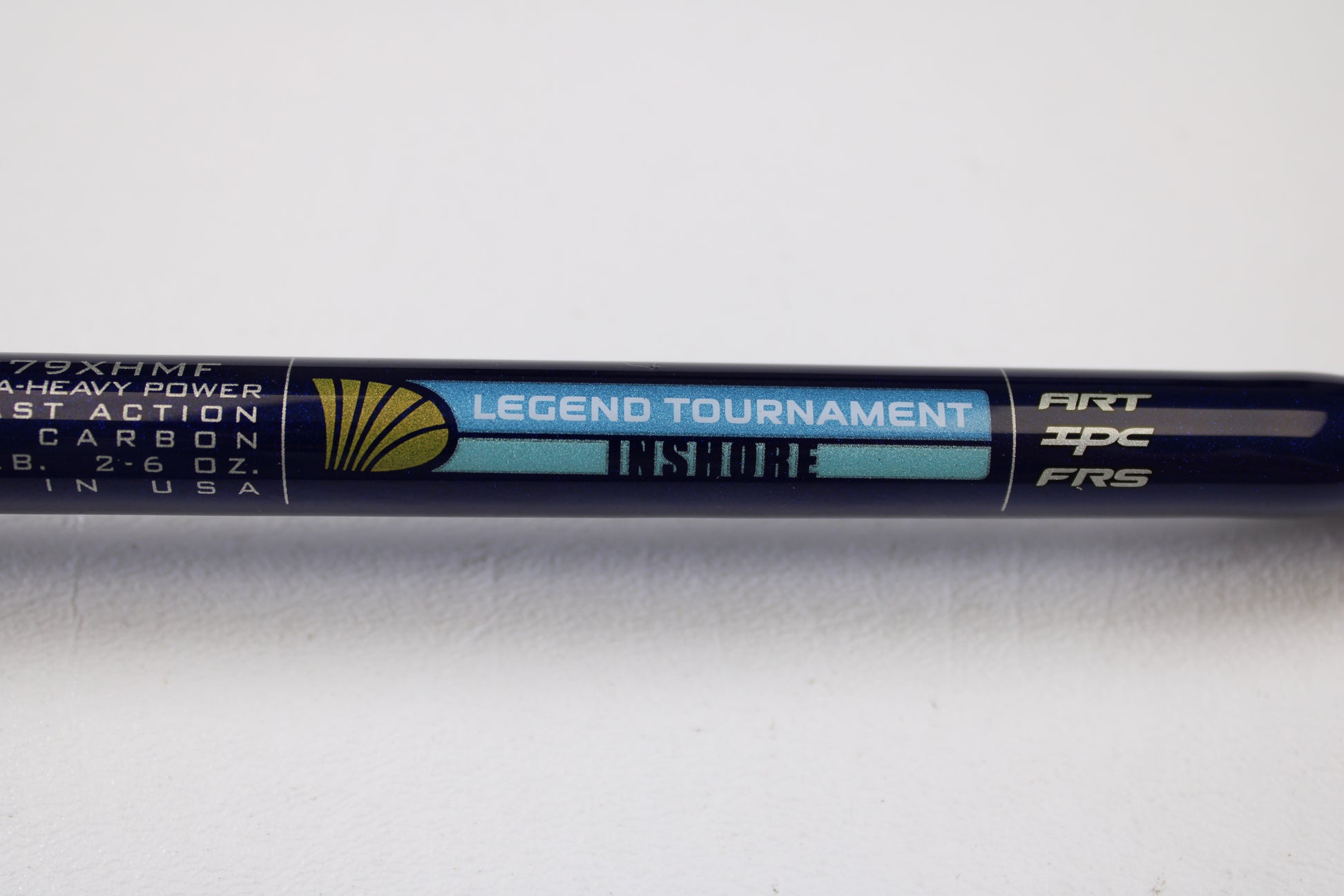 A close-up of a St. Croix Legend Tournament Inshore ITLC79XHMF 7'9" XH used casting rod in mint condition, featuring specs and a gold seashell logo on a blue and black background. Trade in your old gear for store credit with our Rod and Reel Trade-In Program.