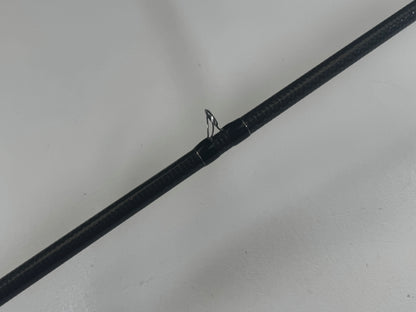 A Daiwa BLXSG721HFB 7'2" Heavy casting rod in excellent condition with a thick cork seal is showcased against a light gray background. Its slightly reflective texture and sleek finish make it perfect for the Rod and Reel Trade-In Program.