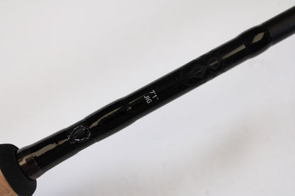 Close-up of a Daiwa Tatula TTU711HFB Used Casting Rod in mint condition, showing "7'1\" JIG" in white text on the black rod against a plain background. Handle is partially visible—ideal for your collection via our rod and reel trade-in program.