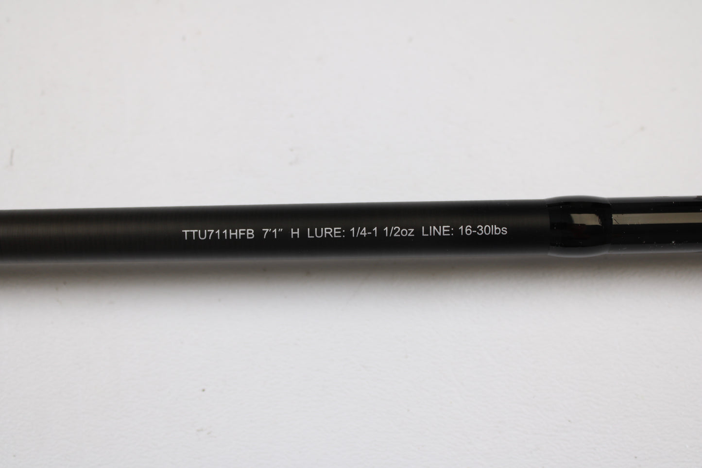 A close-up of a Daiwa Tatula TTU711HFB Used Casting Rod in mint condition, showing specs (7'1" H, Lure: 1/4–1 1/2 oz, Line: 16–30 lbs) against a white background—ideal for our trade-in program or store credit.