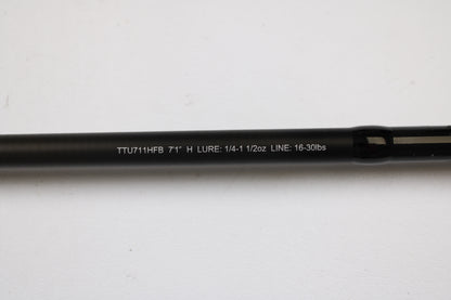 A close-up of a Daiwa Tatula TTU711HFB Used Casting Rod in mint condition, showing specs (7'1" H, Lure: 1/4–1 1/2 oz, Line: 16–30 lbs) against a white background—ideal for our trade-in program or store credit.