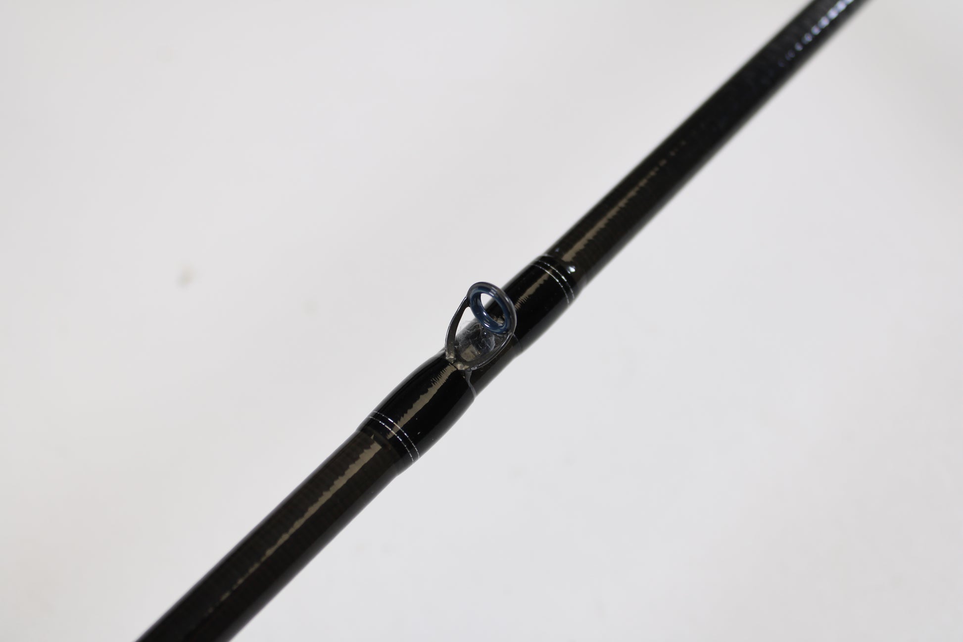 Close-up of a Daiwa Tatula TTU711HFB Used Casting Rod in mint condition, highlighting a line guide against a white background—ideal for those upgrading gear with our trade-in program for store credit.