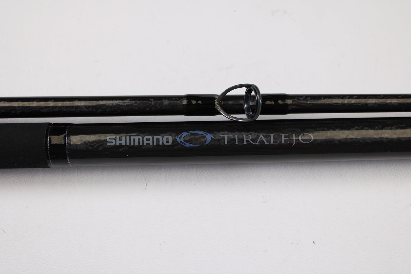Close-up of the Shimano Tiralejo TRS120MHA Used Spinning Rod in mint condition, with silver and blue branding—ideal for anglers considering an upgrade through our Rod and Reel Trade-In Program.