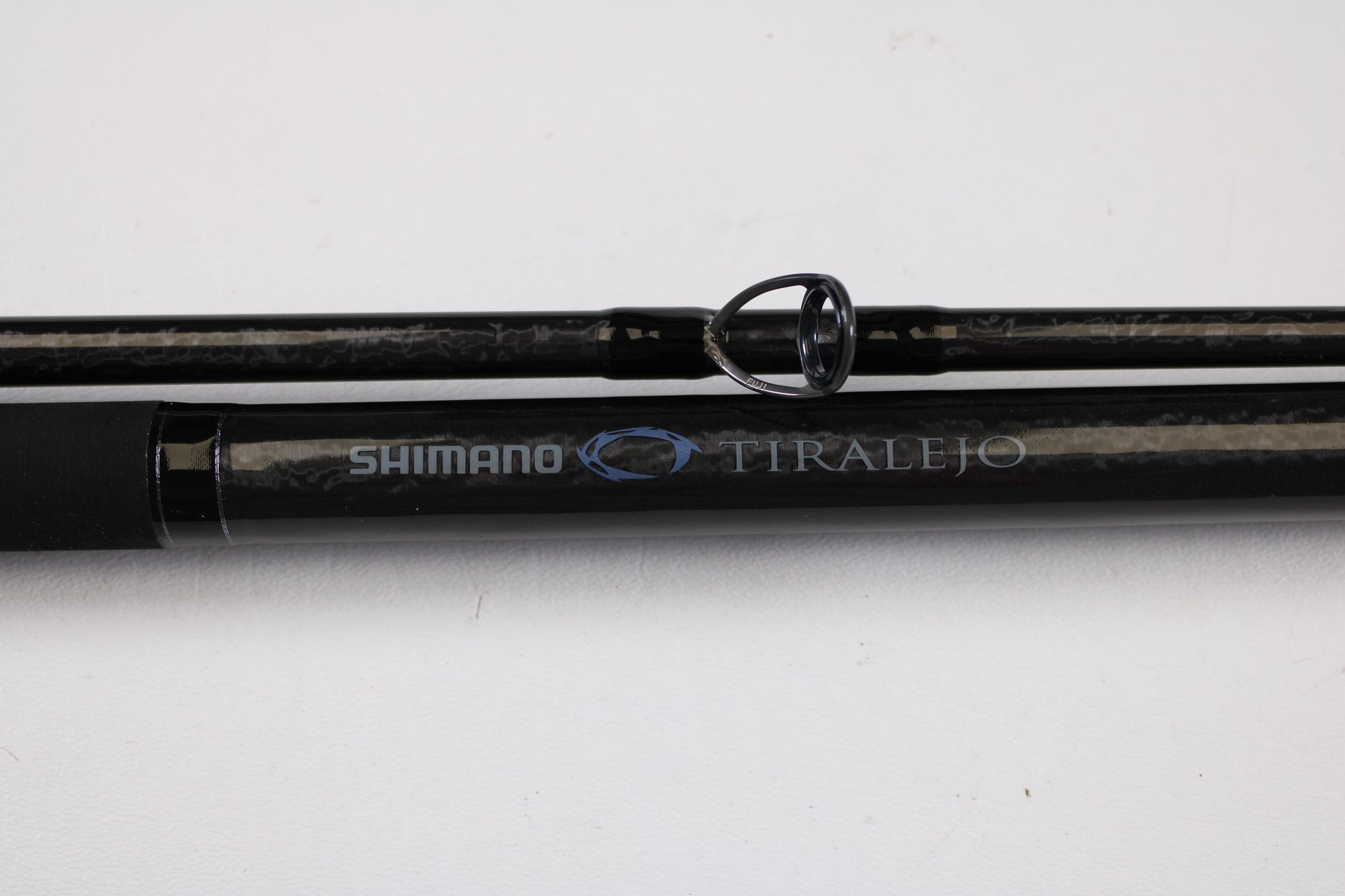Close-up of the Shimano Tiralejo TRS120MHA Used Spinning Rod in mint condition, with silver and blue branding—ideal for anglers considering an upgrade through our Rod and Reel Trade-In Program.
