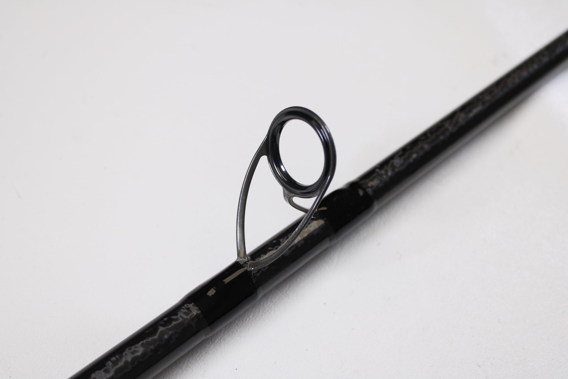 Close-up of a Shimano Tiralejo TRS120MHA Used Spinning Rod in mint condition, featuring a metal guide ring—ideal for trading in through our Rod and Reel Trade-In Program to earn valuable store credit.