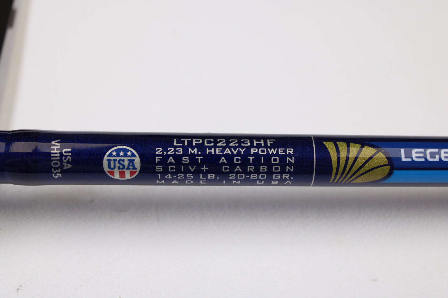 Close-up of a St. Croix Legend Tournament Pike LTPC223HF Slop-N-Tail 7'3" Med Heavy Used Casting Rod (mint) with USA flag and gold shell icon—ideal for our Rod & Reel Trade-In Program or store credit on used gear.