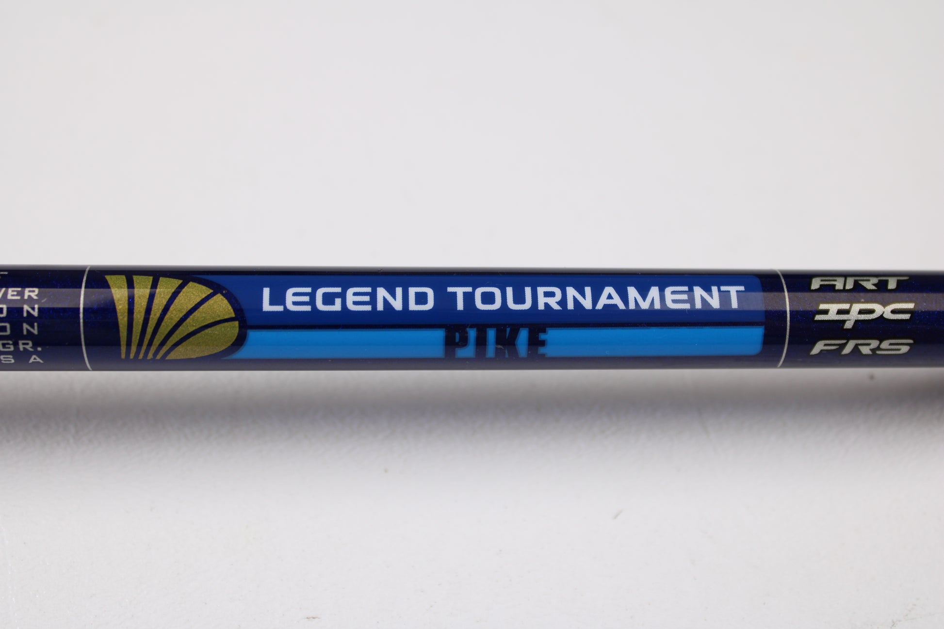 A close-up of a St. Croix Legend Tournament Pike LTPC223HF Slop-N-Tail 7'3" used casting rod—blue with gold and white accents, "ART," "IPC," and "FRS" markings—ideal for our Rod and Reel Trade-In or used gear shopping.