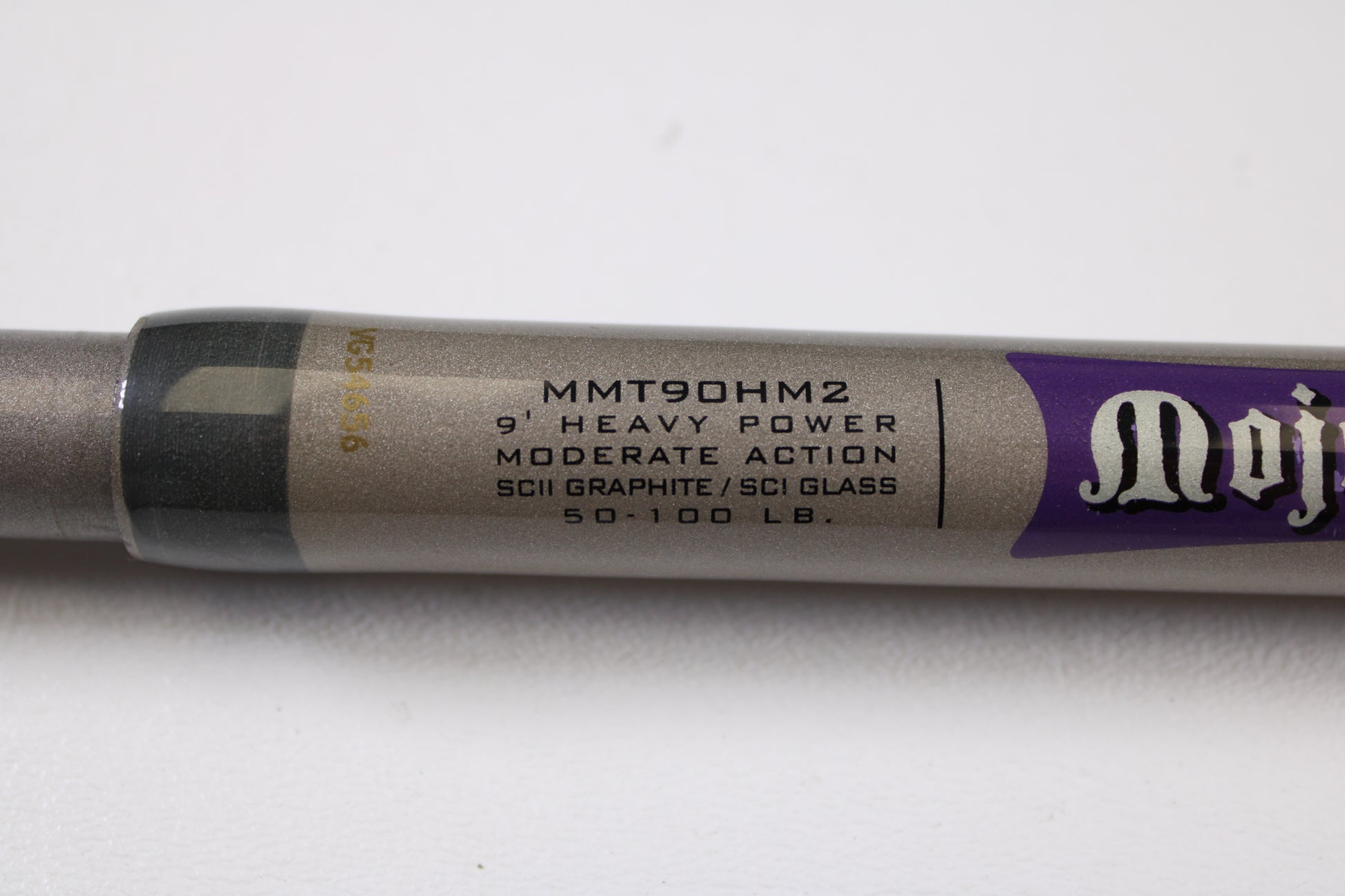 Close-up of a St. Croix Mojo Musky Trolling MMT90HM2 9'0" Heavy casting rod in mint condition, showing printed specs—ideal for those interested in our Rod and Reel Trade-In Program.