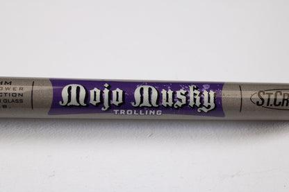 A close-up of a St. Croix Mojo Musky Trolling MMT80HM 8'0" Heavy used casting rod in mint condition features white and purple labeling on gray. Perfect for our Rod and Reel Trade-In Program, the St. Croix branding is partly visible on the right.