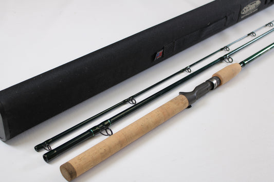 A St. Croix Tidemaster Travel TIC76MHF3 7'6" Medium Heavy 3-piece used casting rod in excellent condition, featuring a cork handle and black case, is shown—ideal for the Rod and Reel Trade-In Program.