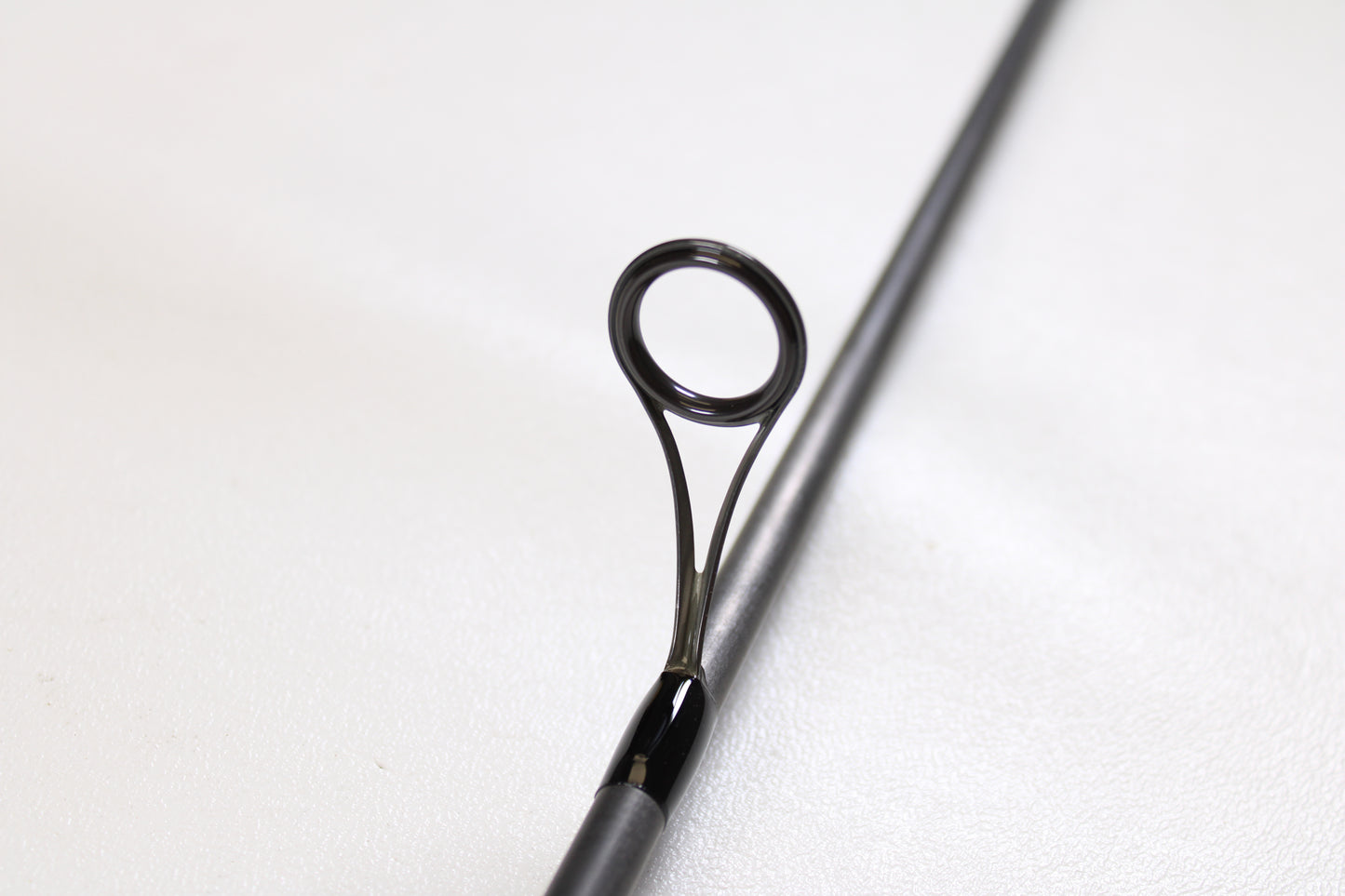 Close-up of a G. Loomis E6X Walleye 782 2S WUR 6’6” Medium 2 Piece Used Spinning Rod in mint condition, showcasing its metal guide—ideal for anglers trading in or upgrading their gear for store credit.