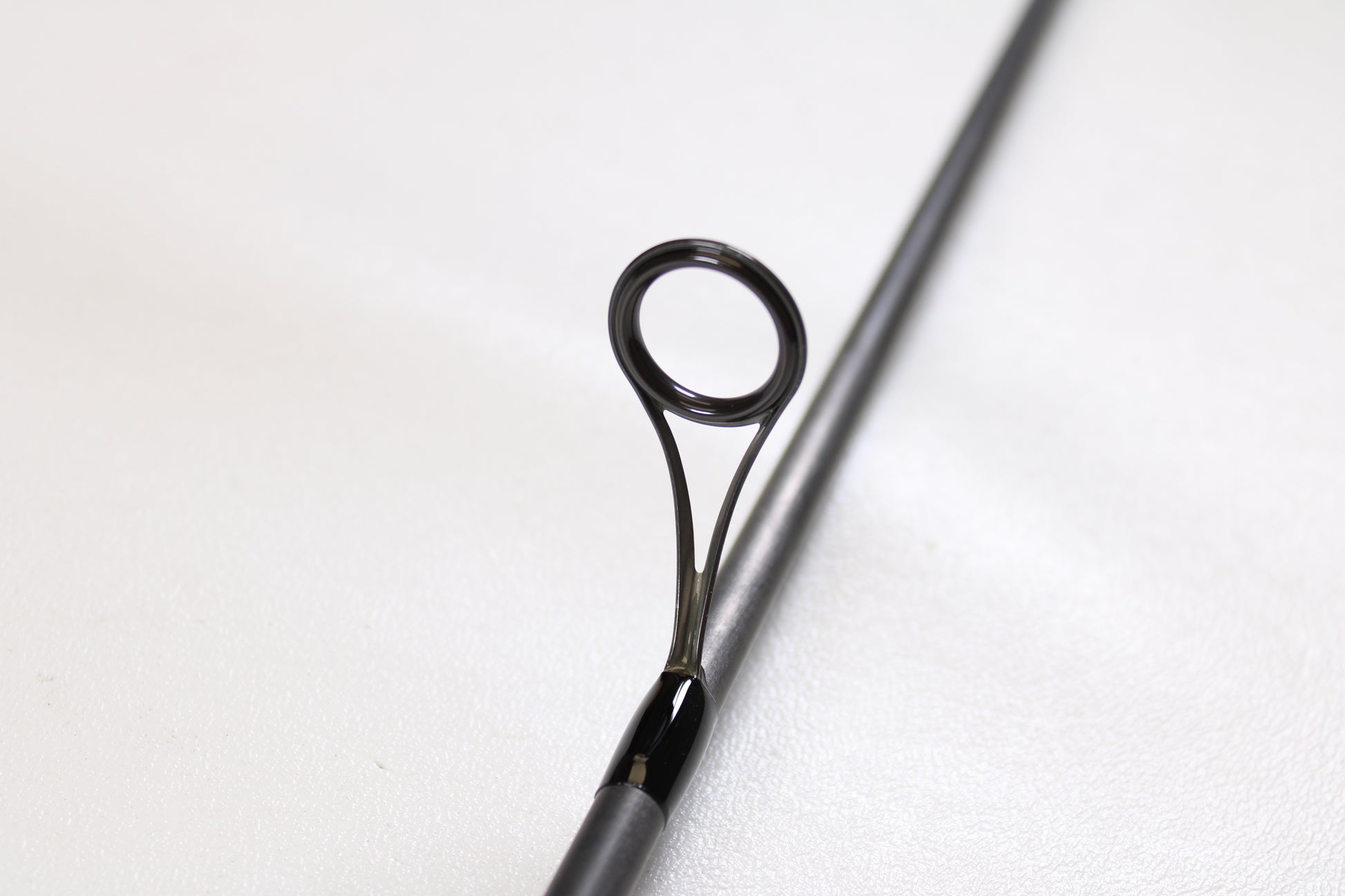 Close-up of a G. Loomis E6X Walleye 782 2S WUR 6’6” Medium 2 Piece Used Spinning Rod in mint condition, showcasing its metal guide—ideal for anglers trading in or upgrading their gear for store credit.