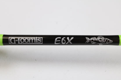 Close-up of a G. Loomis E6X Walleye 782S WUR 6’6” Medium Used Spinning Rod in mint condition, showing the logo, "E6X" text, fish design, and green accents—ideal for our rod and reel trade-in program for store credit.