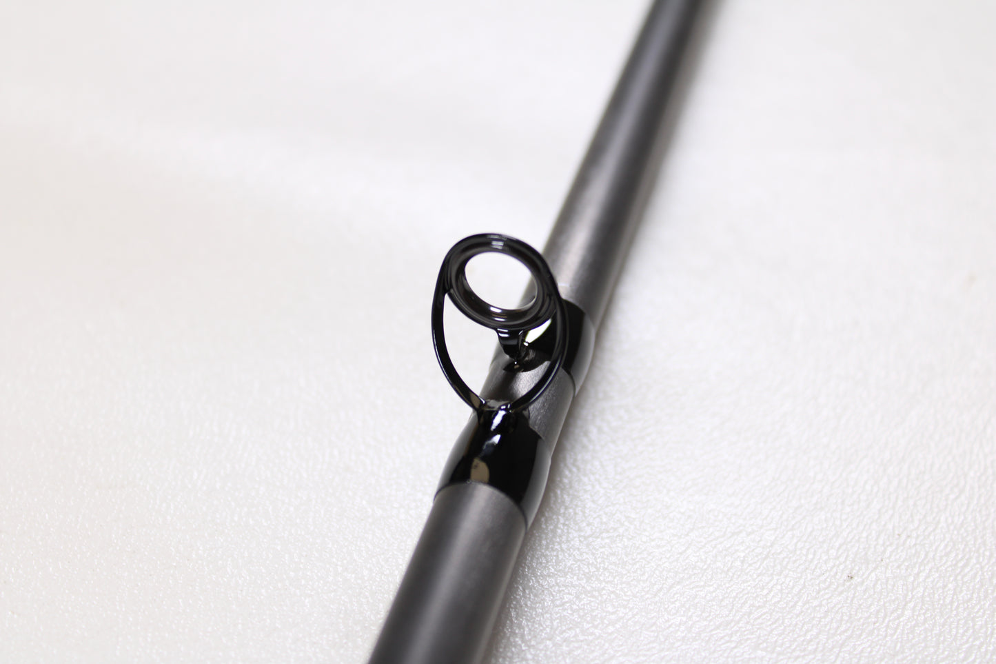 Close-up of the metallic guide ring on a G. Loomis E6X Steelhead 1021-2C HSR GH Used Casting Rod (Mint Condition), ideal for anglers seeking top quality used G. Loomis gear or participating in our rod and reel trade-in program.