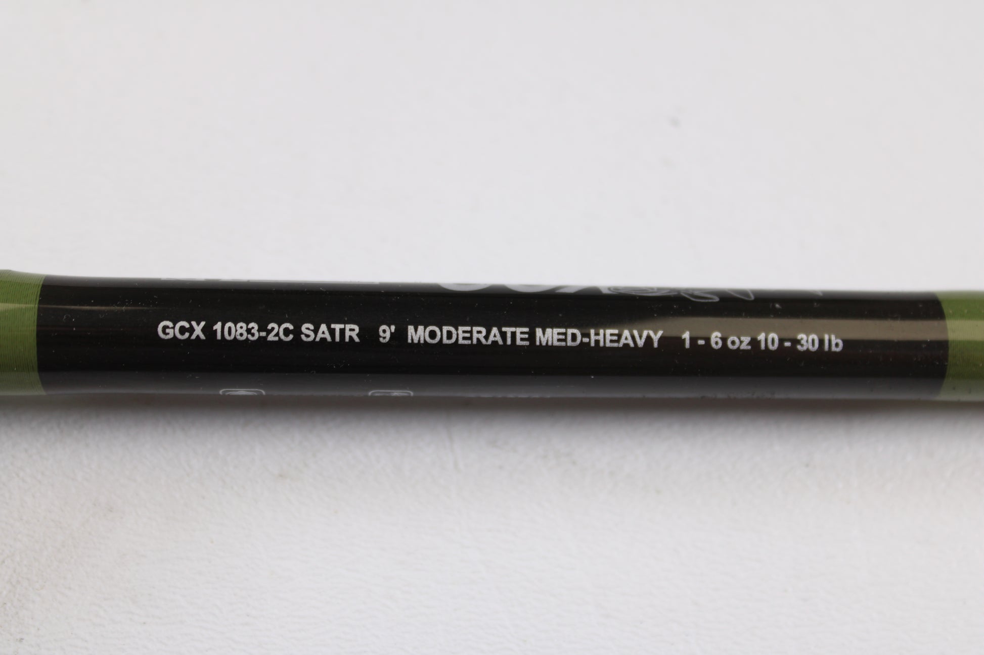 A close-up of a G. Loomis GCX Salmon 1083-2C SATR 9'0" Medium Heavy Used Casting Rod in mint condition. Ideal for shoppers interested in our rod and reel trade-in program or browsing top-quality used gear.