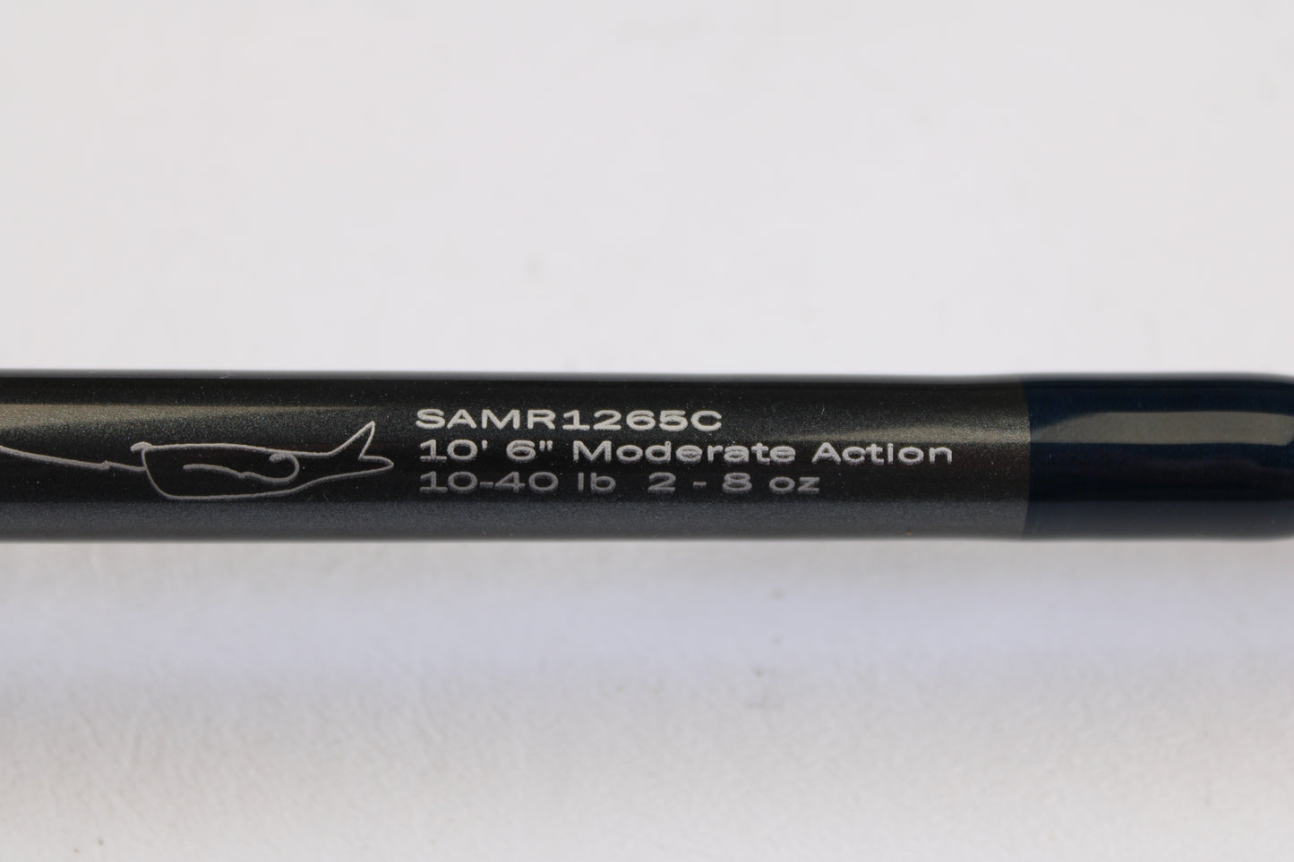 A close-up of the G. Loomis Salmon & Steelhead Mooching SAMR1265C 10'6" Heavy Casting Rod (used, mint) displays white model text, specs, and a fish hook graphic—ideal for our rod and reel trade-in program.